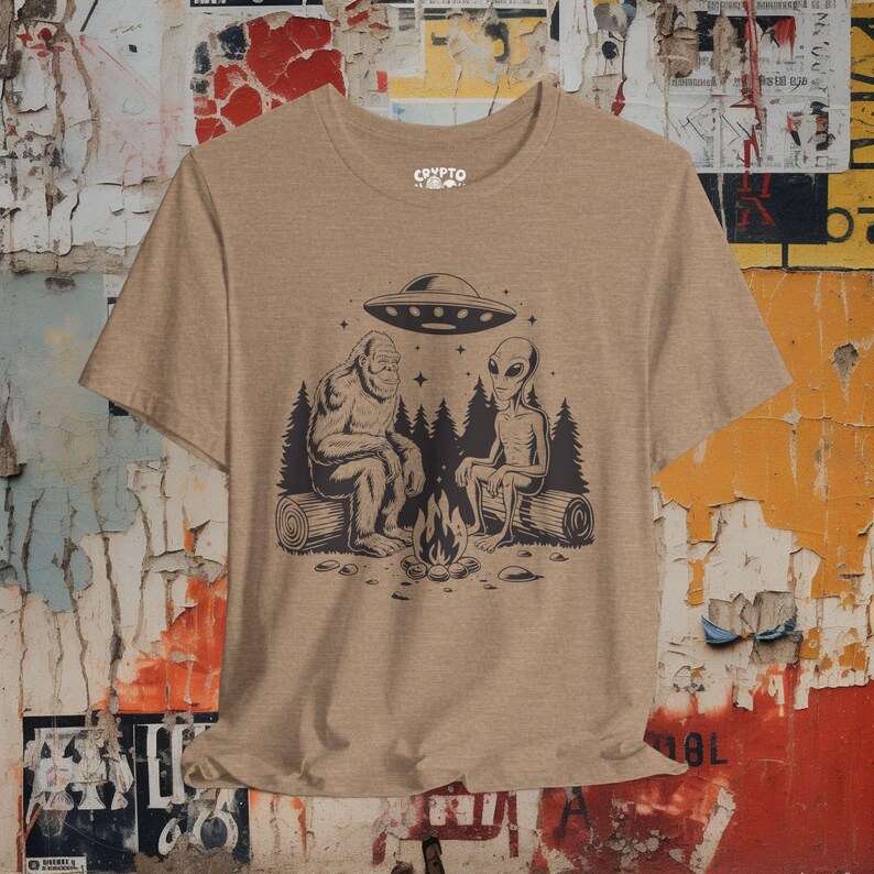 Bigfoot Alien UFO T-shirt Cryptid Campfire Tee Funny Sasquatch Shirt Vintage UFO Graphic Gift for Bigfoot Fans and Cryptid Lovers Heather Tan