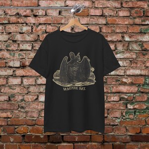 May include: Black t-shirt with a vintage illustration of a vampire bat with the text "Vampire Bat."