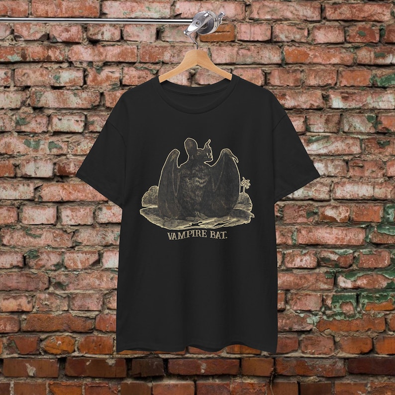 May include: Black t-shirt with a vintage illustration of a vampire bat with the text "Vampire Bat."