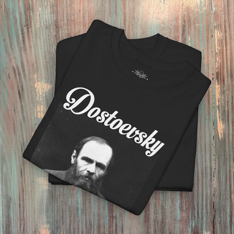 a black t - shirt with a picture of a bearded man on it