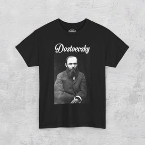 a black t - shirt with a picture of a man in a suit