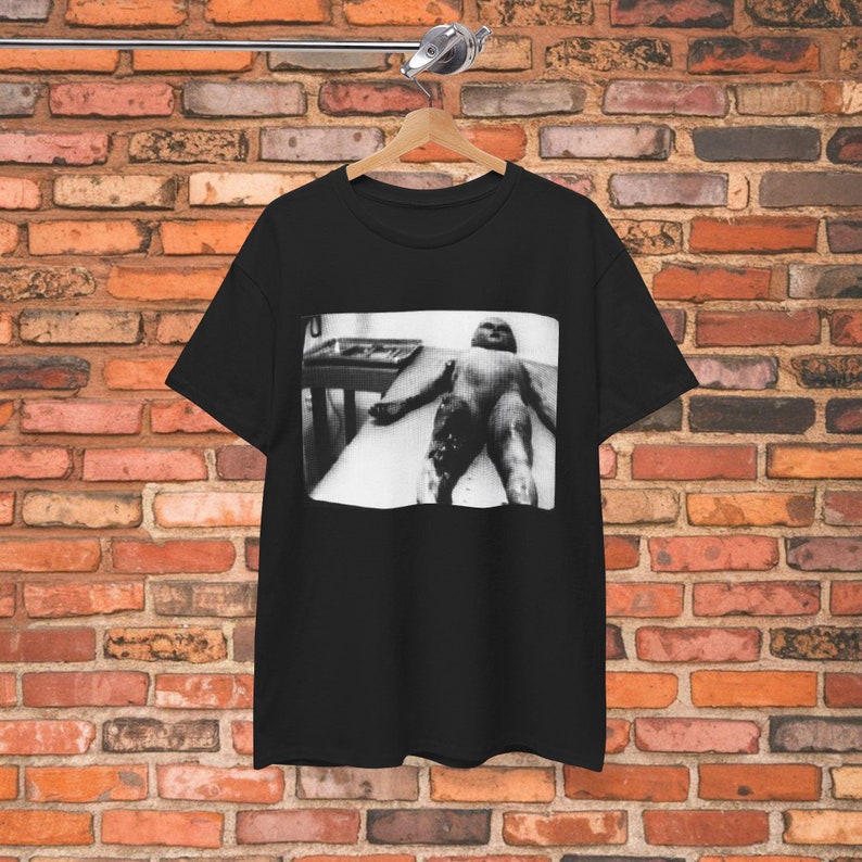 Area 51 alien shirt featuring a UFO autopsy design inspired by Roswell and sci-fi themes. Perfect for paranormal and X-Files fans, this graphic tee is a great gift for alien lovers and conspiracy enthusiasts.