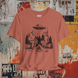 Bigfoot Alien UFO T-shirt Cryptid Campfire Tee Funny Sasquatch Shirt Vintage UFO Graphic Gift for Bigfoot Fans and Cryptid Lovers Heather Clay