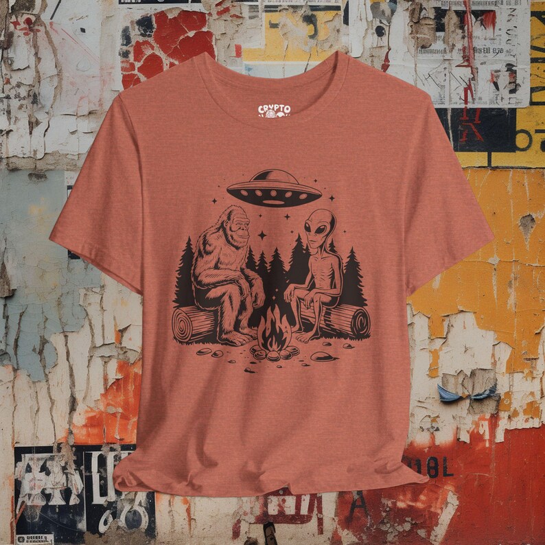 Bigfoot Alien UFO T-shirt Cryptid Campfire Tee Funny Sasquatch Shirt Vintage UFO Graphic Gift for Bigfoot Fans and Cryptid Lovers Heather Clay