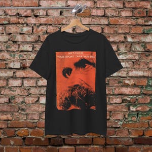 a t - shirt hanging on a brick wall