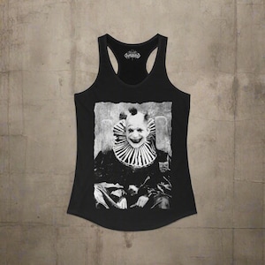 May include: A black racerback tank top featuring a high-contrast, black and white graphic print of a clown wearing a ruffled collar. The clown has a wide, toothy grin and dark eye makeup. The text Cryptidous is printed inside the neckline.