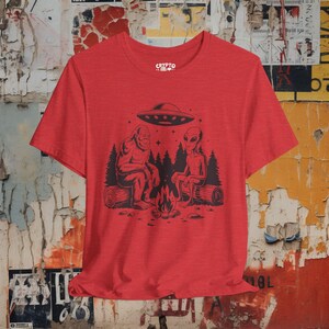 Bigfoot Alien UFO T-shirt Cryptid Campfire Tee Funny Sasquatch Shirt Vintage UFO Graphic Gift for Bigfoot Fans and Cryptid Lovers Heather Red