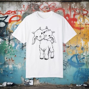 Weird two-headed goat punk shirt with occult themes. Distressed vintage-style creepy animal tee for goths, rockers, and oddities lovers. Unisex alternative fashion statement for dark aesthetic fans.