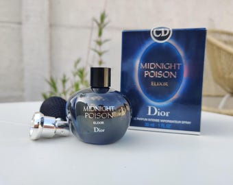 May include: A dark blue perfume bottle and box set. The bottle is round with a black cap, and the box features the words "MIDNIGHT POISON ELIXIR Dior". The set includes a black atomizer and a silver nozzle. The bottle contains 30 ml - 1 fl oz.
