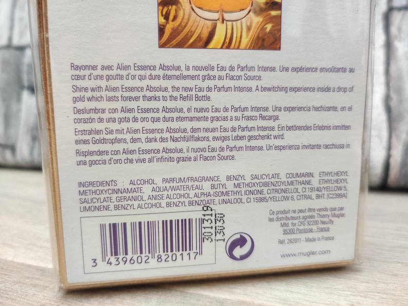 May include: Close-up of a perfume box with text in multiple languages, including English and French. The box lists ingredients and a barcode. The brand name is visible.