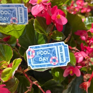 May include: A close-up of a vibrant plant with bright pink flowers and green leaves. Two blue and white "Pool Day" tickets with a life preserver graphic are visible, with the words "Admit One".