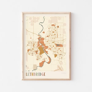 Puede incluir: Una impresión enmarcada de un mapa de Lethbridge, Canadá, en un estilo minimalista. El mapa presenta un fondo beige con detalles marrones y naranjas, incluyendo carreteras, edificios y un río. La palabra "Lethbridge" está impresa en la parte inferior.