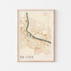 May include: A framed map print of Tri-Cities, Washington, USA. The map features a beige and brown color scheme with a blue river running through the center. The text "TRI-CITIES" is displayed at the bottom.