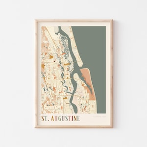 May include: A framed map print of St. Augustine, Florida, USA. The map features a detailed illustration of the city's layout, with streets, waterways, and landmarks in muted tones of beige, brown, and green. The words "ST. AUGUSTINE" are printed at the bottom.