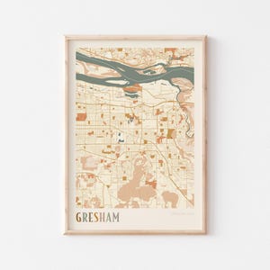 May include: A framed map print of Gresham, Oregon, USA. The map features a beige background with brown, orange, and teal accents. The city name is displayed in a brown font at the bottom of the print.