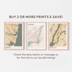 a white wall with three framed maps on it
