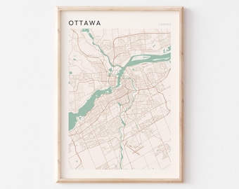May include: Framed map print of Ottawa, Canada. The map has a beige background with brown roads and green water features. The word "Ottawa" is printed in black at the top left, with "Canada" at the top right.