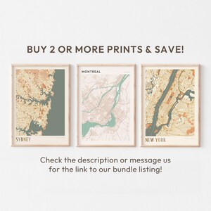 a white wall with three framed maps on it