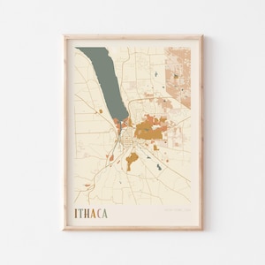 May include: A framed map print of Ithaca, New York, USA. The map features a muted color palette with shades of beige, brown, and green. The word "ITHACA" is printed in a brown font at the bottom of the print.