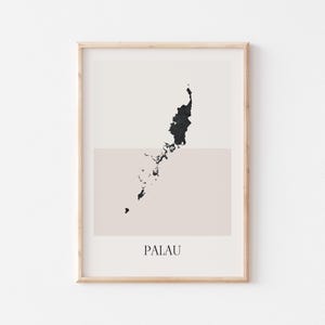 May include: A framed print with a minimalist map of Palau in black on a beige and cream backdrop. The word "PALAU" is printed at the bottom. The frame is a light wood colour. The artwork is a modern, simple design.