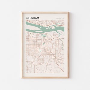 May include: Framed map print of Gresham, Oregon, USA. The map features a network of brown roads and streets against a beige background. The water is a light green color. The word "Gresham" is printed at the top.