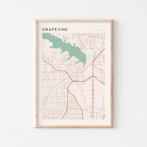 May include: Framed map print of Grapevine, Texas, USA. The map shows a detailed street layout in brown tones, with a light green area representing a lake. The word "GRAPEVINE" is at the top left.