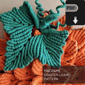 May include: A PDF pattern for a macrame coaster with a leaf design. The coaster is made with orange and green yarn.