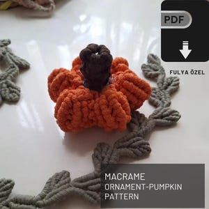 May include: A PDF pattern for a macrame pumpkin ornament. The pattern is by Fulyä Özel. The image shows a finished pumpkin ornament in orange and brown.
