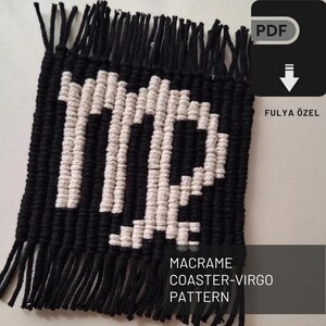 May include: Black and white macrame coaster with the astrological symbol for Virgo. The coaster has a fringe border. The text "MACRAME COASTER-VIRGO PATTERN" is at the bottom of the image.