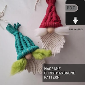 May include: Two macrame Christmas gnomes, one with a red hat and the other with a teal hat. Both gnomes have white beards and a wooden nose. The image includes the text "MACRAME CHRISTMAS GNOME PATTERN" and "FULYA ÖZEL"