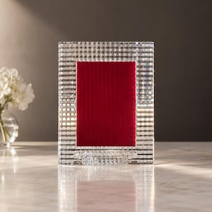 May include: A rectangular picture frame featuring a clear, faceted glass border with a grid-like pattern. The center of the frame is filled with a solid, deep red velvet insert, providing a stark contrast to the reflective, textured glass exterior.