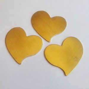 May include: Three gold-colored metal heart shapes.