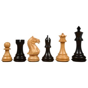 May include: A set of six wooden chess pieces, including a pawn, rook, knight, bishop, queen, and king. The pieces are two-toned, with natural wood and black finishes. The chess pieces are arranged in a row against a white background.