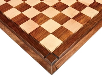 May include: A wooden chessboard featuring a classic alternating grid pattern of light maple and dark walnut squares. The board has a thick, solid walnut border with beveled edges, showcasing the natural wood grain and a smooth, polished finish.