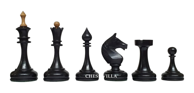 Op de afbeelding: Een set van zes zwarte houten schaakstukken, waaronder een koning met een licht houten knop, dame, loper, paard, toren en pion. De tekst CHESS VILLA is in het wit gedrukt op de voet van de loper en het paard tegen een effen achtergrond.