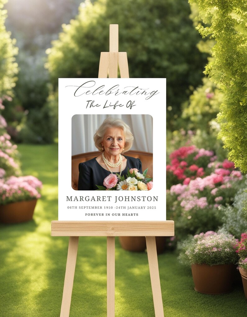 May include: A white easel with a sign that reads "Celebrating The Life Of" with a photo of a woman and the text "Margaret Johnston 06th September 1950 - 24th January 2025 Forever in Our Hearts".