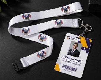 May include: White lanyard with a repeating eagle design in red, white, and blue. The lanyard is connected to an ID badge with a photo, the name "Jamie Jhonson", and the title "Assistant Manager".