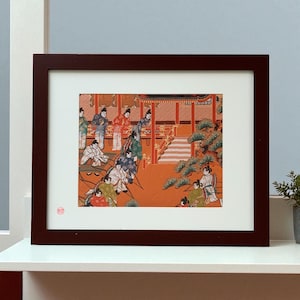 May include: Framed Japanese woodblock print depicting figures in traditional attire within a temple setting. The artwork features a vibrant color palette with orange, red, and green hues. The print is encased in a dark brown wooden frame.