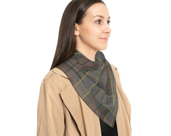 May include: A woman wearing a beige trench coat with a gray, red, and yellow plaid scarf around her neck.