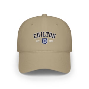 May include: A tan baseball cap with a navy blue embroidered logo that says "Chilton Est. 1803" with a crest in the middle.