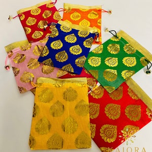 May include: Assortment of colorful drawstring pouches with gold patterned designs. The pouches are made of a soft fabric and have a drawstring closure. The pouches are perfect for storing small items like jewelry, coins, or gifts.