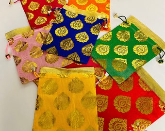 May include: Assortment of colorful drawstring pouches with gold patterned designs. The pouches are made of a soft fabric and have a drawstring closure. The pouches are perfect for storing small items like jewelry, coins, or gifts.