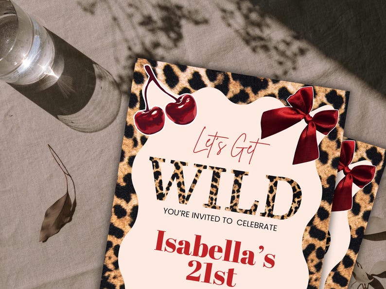 May include: Two party invitations with a leopard print border and the words "Let's Get WILD" in a bold font. The invitations also include the text "You're invited to celebrate Isabella's 21st" in red. The design includes red cherries and bows.