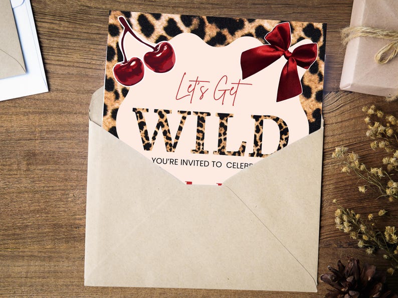 May include: An invitation card with a leopard print background and the words "Let's Get WILD" in bold letters. The card features a red bow and cherries, and is partially inside a kraft paper envelope.