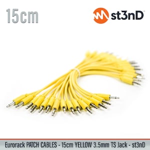 May include: A bundle of bright yellow 15cm (5.9 inches) Eurorack patch cables with 3.5mm TS jacks. The cables are tied together and ready for use. The st3nD logo is visible in the upper right corner.