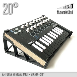 May include: A black Arturia Minilab MKII keyboard with white keys and knobs, mounted on a wooden stand at a 20-degree angle. The stand is made of wood with a light brown finish. The keyboard is labeled "ARTURIA" and "MINILAB MKII".