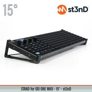 May include: Black OXI ONE MKII stand angled at 15 degrees. The stand features a grid of small black squares, several knobs, and the text "INSTRUMENTS". The stand is designed to elevate the OXI ONE MKII.