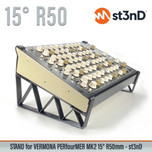 May include: Black metal stand with a 15 degree angle and 50mm depth, designed to hold a Vermona PerfourMer MK2 synthesizer. The stand is made of sturdy metal and features a triangular base for stability. The stand is labeled "st3nD" and "15° R50".