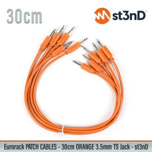May include: A set of orange 30cm patch cables with 3.5mm TS jacks, featuring the st3nD logo. These cables are designed for Eurorack modular synthesizers and are bundled together with a small white tie, showing the text 30cm and st3nD.