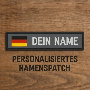 May include: A black and gray personalized name patch with a German flag and the text "DEIN NAME" and "PERSONALISIERTES NAMENSPATCH".